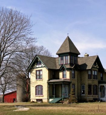 Beautiful shot of a big farmhouse in a clear blue sky